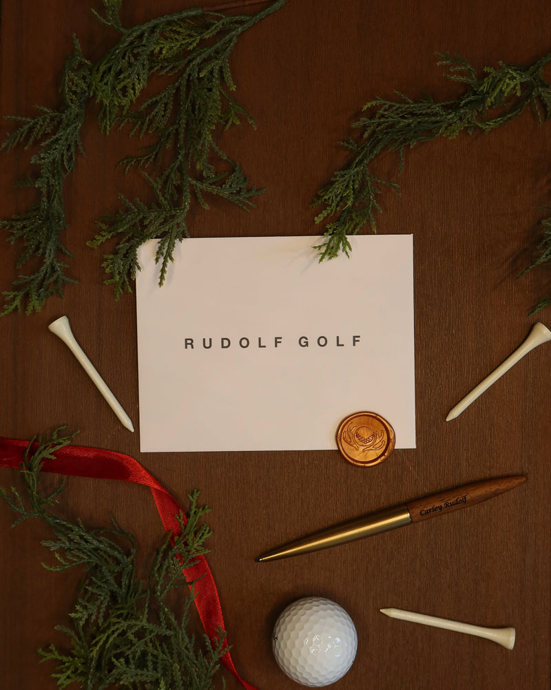 Women’s golf skort and polo gift set tied with a red bow